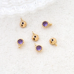 Detailed view of DIY jewelry making accessories with purple zircon in gold plating