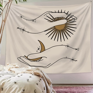 Bohemian sun and moon tapestry hanging above a cozy bed in a minimalist bedroom decor