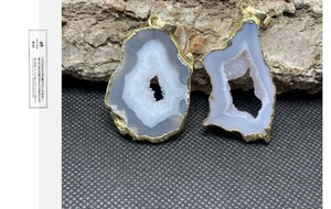 Dettaglio di pendenti in geode di agata naturale irregolare con bordi placcati oro 14K