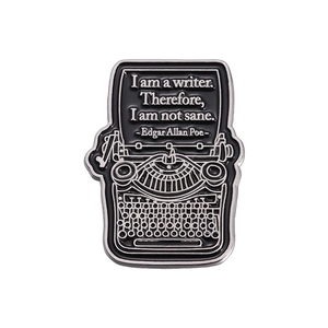 Vintage typewriter enamel pin with Edgar Allan Poe quote on white background