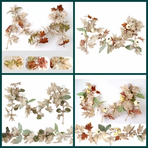 Macro detail of artificial maple leaves and white pumpkins on decorative autumn garlands