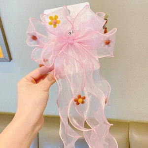 Detailed view of pink organza bow hair clip with colorful felt flowers for girls