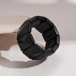 Detailed macro view of black matte geometric block bracelet with a modern textured finish