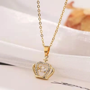 Macro shot of a gold crown pendant necklace with floating crystal inlay details