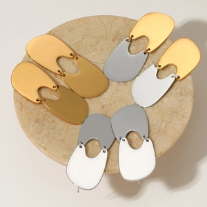 Polished 316 stainless steel geometric earrings on marble display with gold mirror finish
