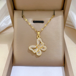 Close-up of a gold butterfly necklace with hollow design and sparkling zircon in a gift box