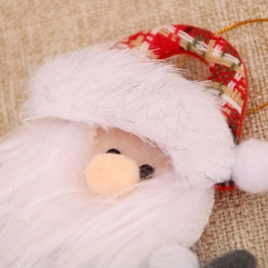 Close-up of Santa Claus hanging ornament with white plush and red plaid knit details