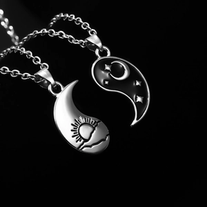 Tai Chi Yin Yang couple necklace set in black and silver finishes on dark background