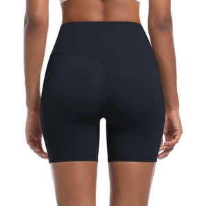 Detail of high-waisted black yoga shorts showing V-shape seams and lifting effect