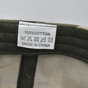 Detailed close-up of 100% cotton care label and stitching on washed US flag baseball cap