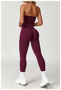 Back view of a backless purple yoga top and high-waisted seamless leggings set