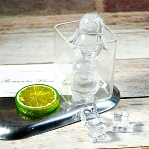 Detail of penguin-shaped silicone ice mold showing dual cavities in a clear tray