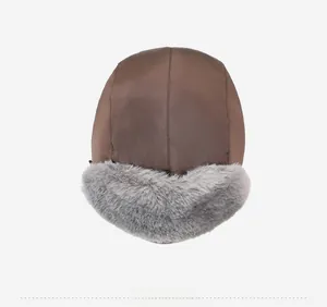 Top down view of a winter trapper hat with dark brown fabric and grey faux fur lining