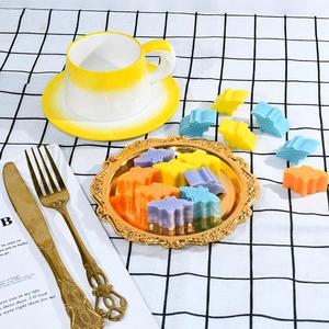 Colorful silicone bat-shaped molds on a vintage tray for Halloween baking and crafts