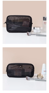Detail showing the capacity of the black mesh toiletry bag with cosmetics and brushes