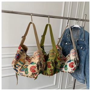 Detail of vintage canvas tote bags featuring diverse retro prints and wide straps