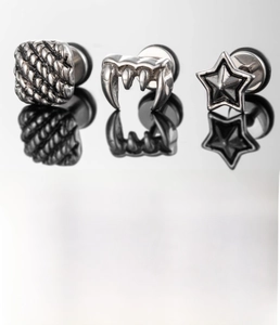 Detailed view of silver titanium steel earrings in square, claw and star shapes