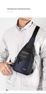 Front-view detail of a stylish black and blue cross-body chest bag on a male model