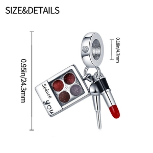 Detailed silver makeup charm with eyeshadow palette, makeup brush, and red lipstick pendant