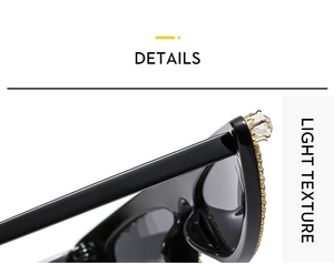 Detail of cat-eye sunglasses featuring black frames with gold hardware and crystal studs