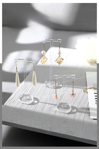 Three transparent acrylic T-bar earring display stands in varying heights for jewelry showcase