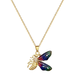 Gold titanium bee necklace with colorful wings and clear rhinestones on white backdrop