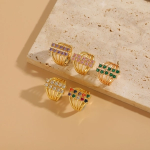 Close-up of multi-layer 14K gold plated rings featuring colorful zircon stones on stone