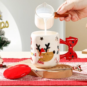 Detail of Christmas ceramic mug with red bow handle, elk pattern and wooden lid set