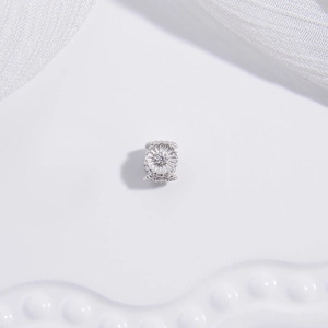 Macro detail of S925 sterling silver four-leaf clover flower bead with a central diamond stone