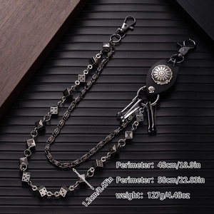 Detail of punk double-layer metal wallet chain with dice pendants and leather concho