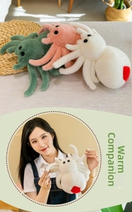 Detailed view of plush spider toys in white with red heart and green and pink colors
