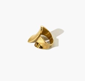 Macro view of polished 18K gold-plated wide wave ring showing smooth metallic finish