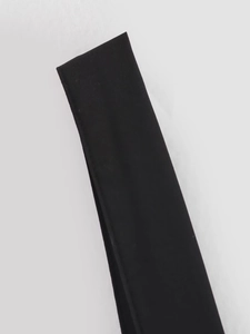Detailed close-up showing the premium black woven fabric texture and glossy finish