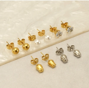 Detailed close-up of stainless steel stud earrings set with pearls and zircons