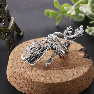 Retro hip hop silver dragon ring with adjustable open design on a wooden display