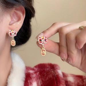 Detail of lion dance earrings with traditional Chinese lucky charms and enamel finish