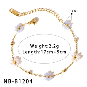 Detail view of a gold stainless steel bracelet with blue and white floral beads