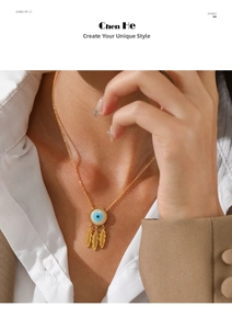 Detail of gold evil eye necklace with three feather pendants worn by a female model