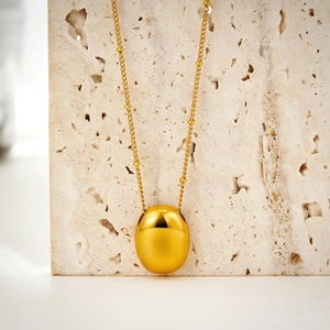 Minimalist 18K gold plated stainless steel necklace with oval bean pendant on stone