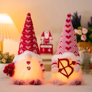 Close-up of glowing Valentine's Day gnomes with roses and hearts for home decor