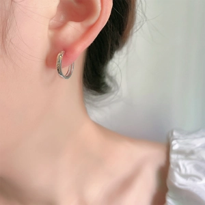 Minimalist S925 sterling silver hoop earrings shown on model in a polished silver finish