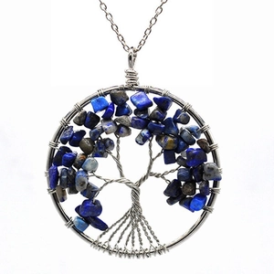Detail view of handmade silver wire wrapped life tree pendant with blue natural stones