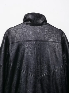 Detail of black faux leather jacket showing high collar and textured back panel