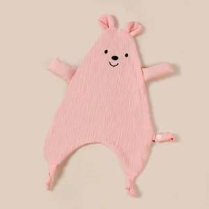 Detail of pink cotton muslin baby security blanket with bear head and knotted corners