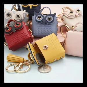 Macro shot of colorful owl mini purses with leather tassels and gold lobster clasps
