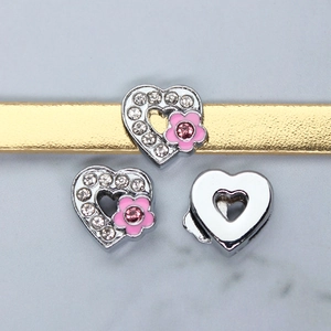 Macro view of crystal heart slider charms with pink flower for 8mm DIY wristbands