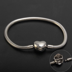 Polished stainless steel heart clasp snake chain bracelet with a detailed toggle closure view