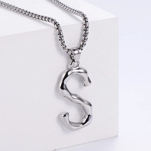 Vue macro du pendentif lettre S en argent 3D avec une chaîne maille vénitienne