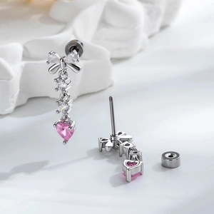 Silver bow stud earrings featuring pink heart zircon stones and tassel drop design