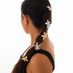 Detail of floral hair ties with pearls on braid, polished gold and silver finish